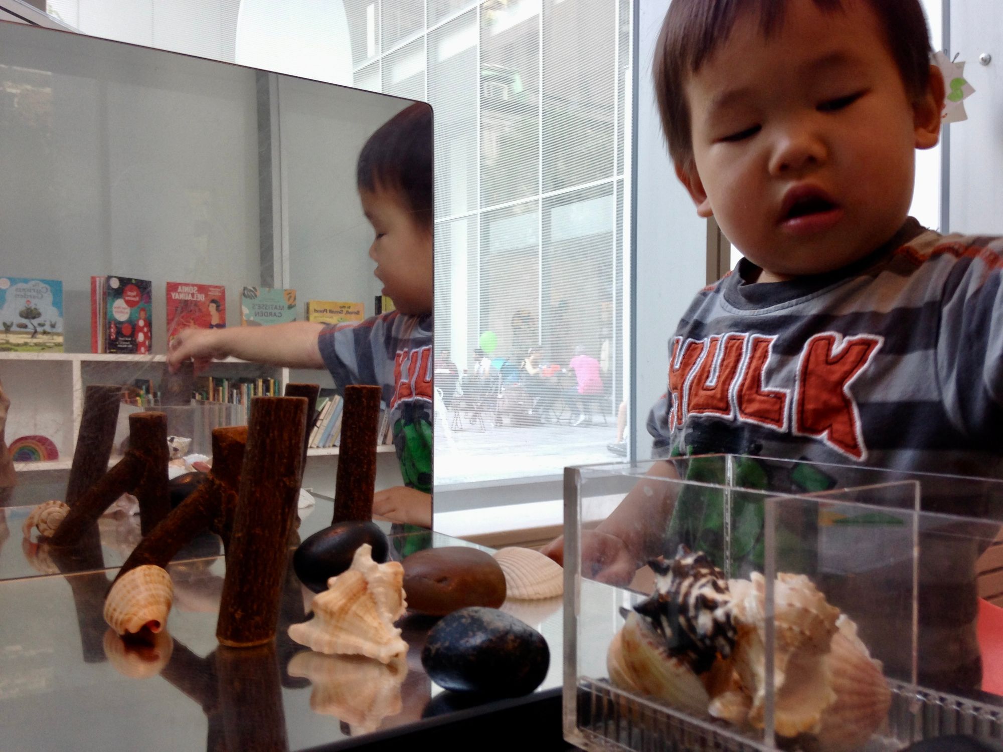 Two year old experimenting with reflections at MoMA art lab