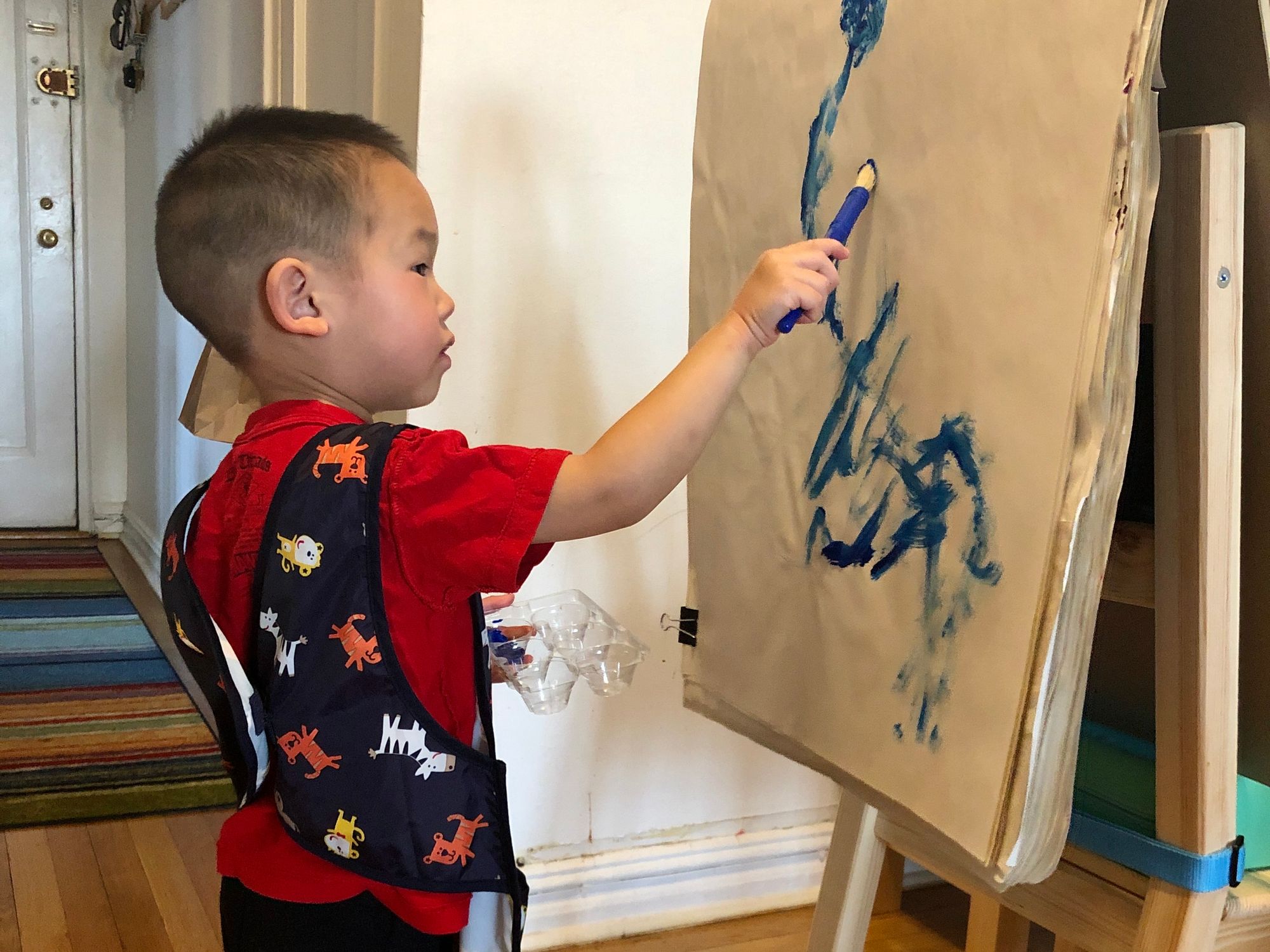 Toddler painting with paintbrush