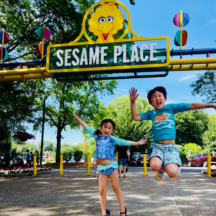 Kids jumping in front of entrance to Sesame Place, Langhorne, Pennsylvania 